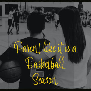 A mother watches a basketball game next to her son. He wears a basketball jersey and holds a basketball. The text in yellow says: "Parent like it is a basketball season".