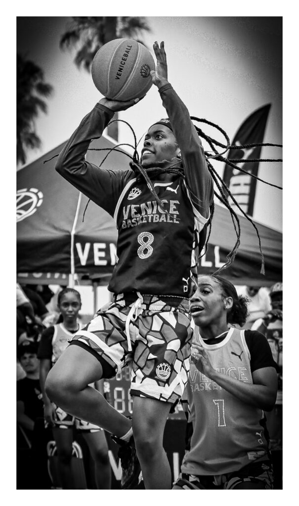 A female basketball player is seen shooting the ball during an outdoor game at Venice Beach in California.